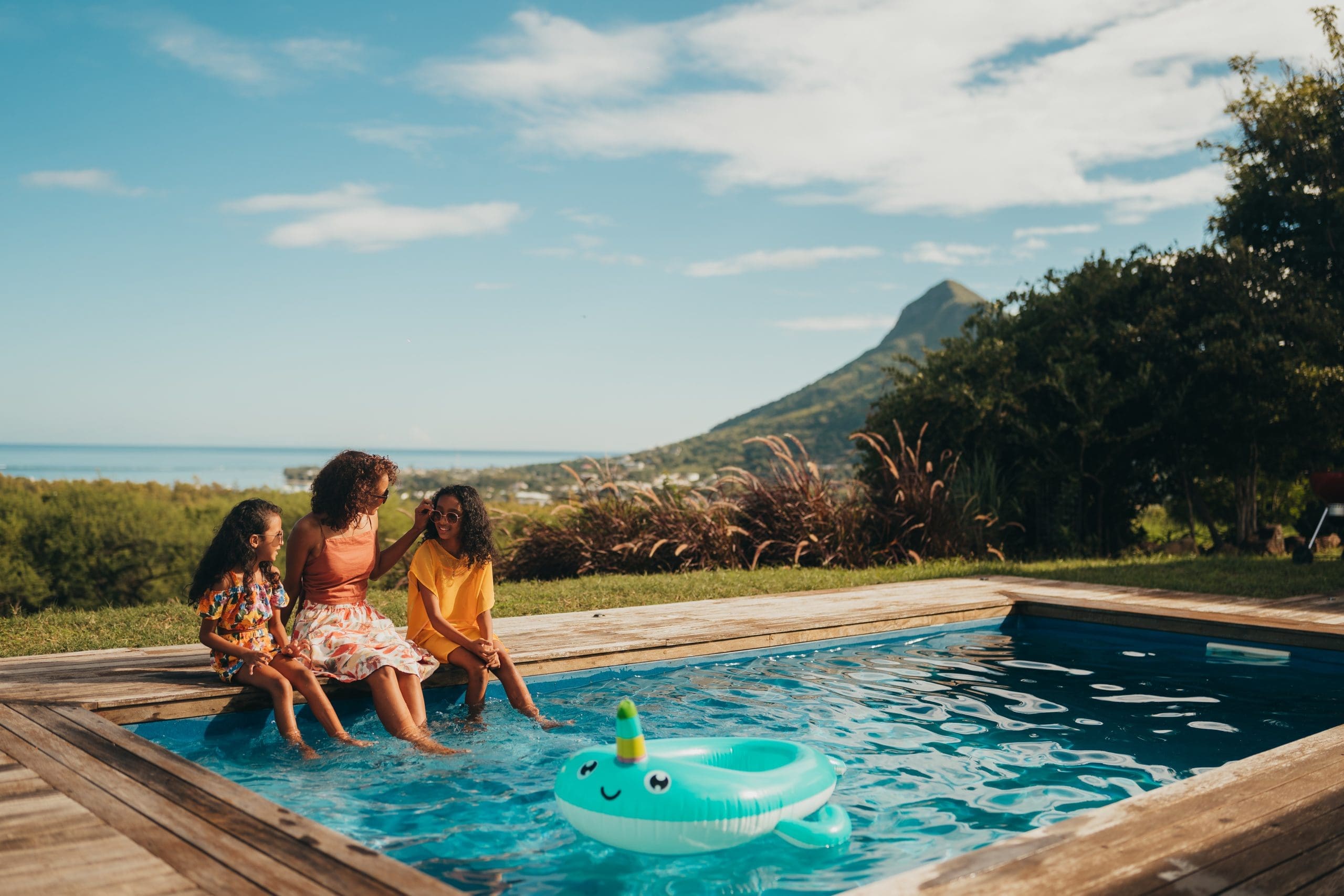 Family enjoying a sunny day by the pool.