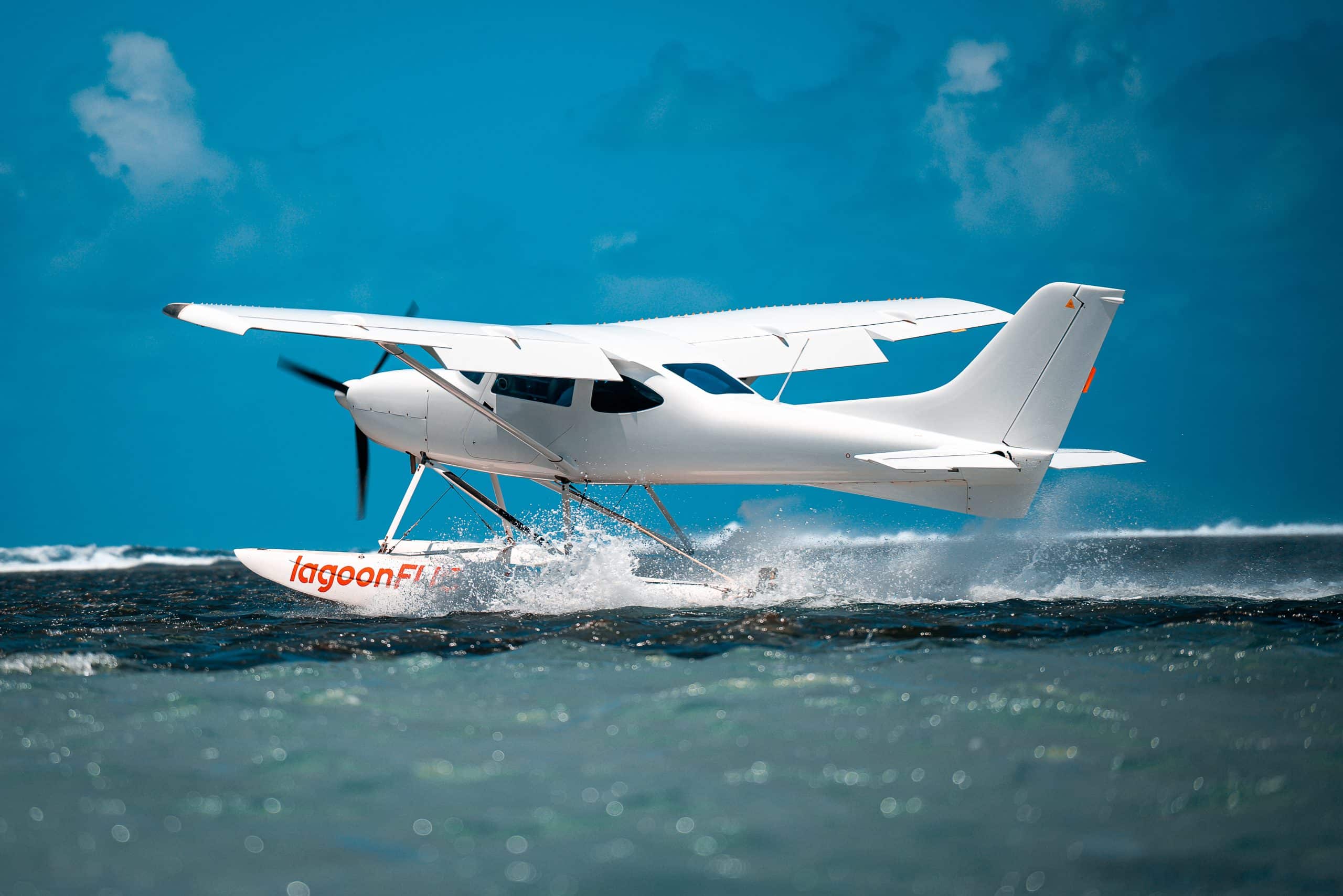 Seaplane taking off from water with splash